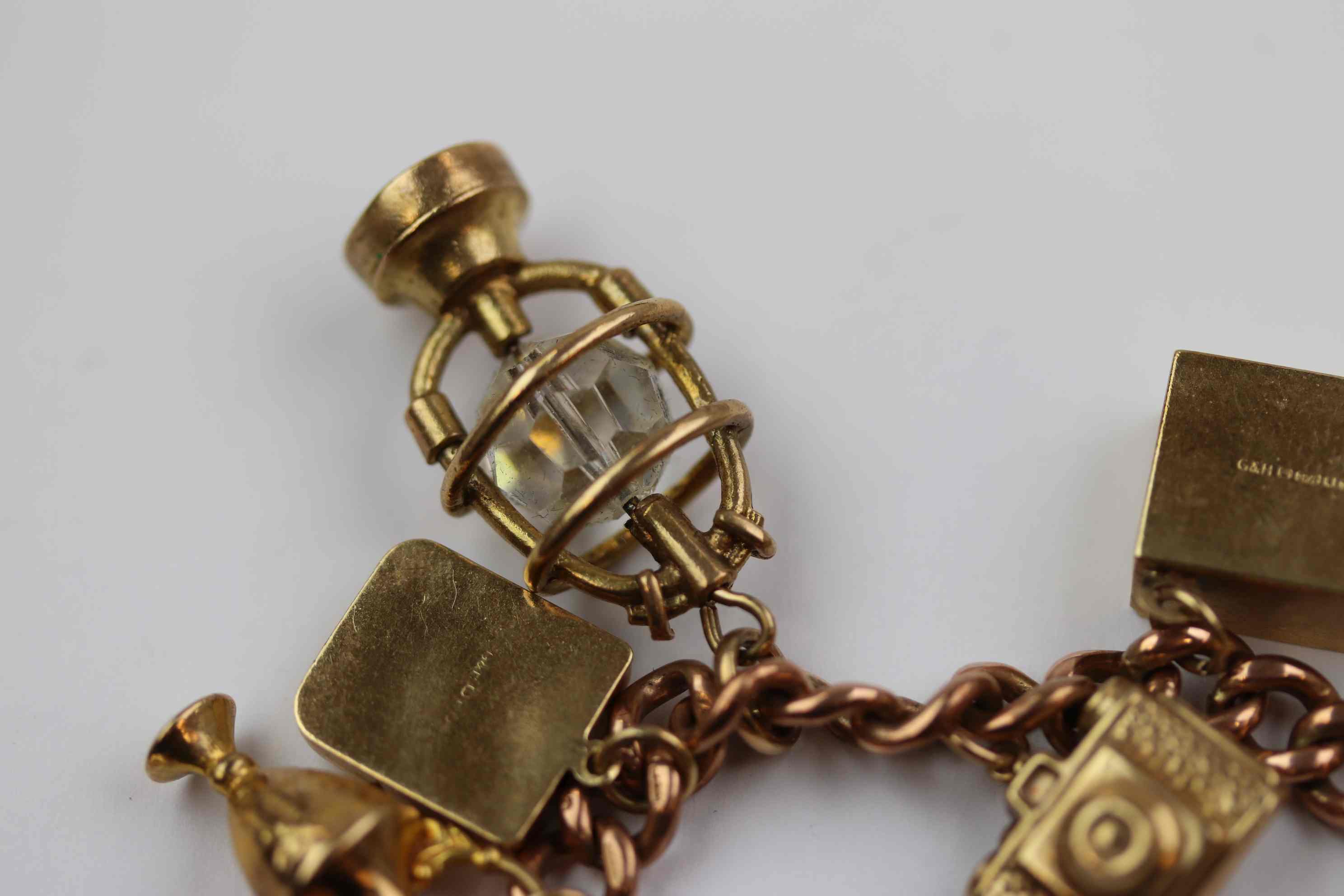 9ct rose gold curb link charm bracelet with 9ct yellow gold padlock clasp, seventeen charms in total - Image 7 of 12