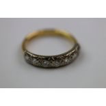 Diamond seven stone 18ct yellow gold and white gold set half eternity ring, seven round brilliant