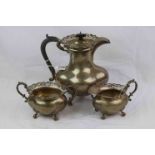 George V three piece silver tea service comprising teapot, milk jug and sugar bowl, each raised on