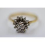 Diamond 18ct yellow gold and white gold set flower head cluster ring, the central round brilliant