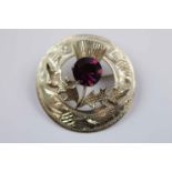 Mid twentieth century Scottish silver paste set thistle brooch, purple paste stone forming the