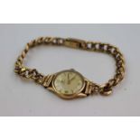 Mid 20th century ladies Omega 9ct gold cased wristwatch, champagne dial, baton markers and Arabic