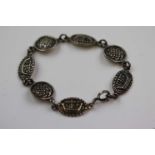 Silver panel bracelet depicting in relief Viking long boats and stylised Celtic knot design in