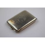 George V silver pocket cigarette case, engine turned decoration with initialled circular cartouche