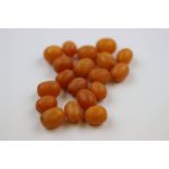 Nineteen oval butterscotch amber type beads, dimensions approximately 13mm x 11mm to 16mm x 12mm,