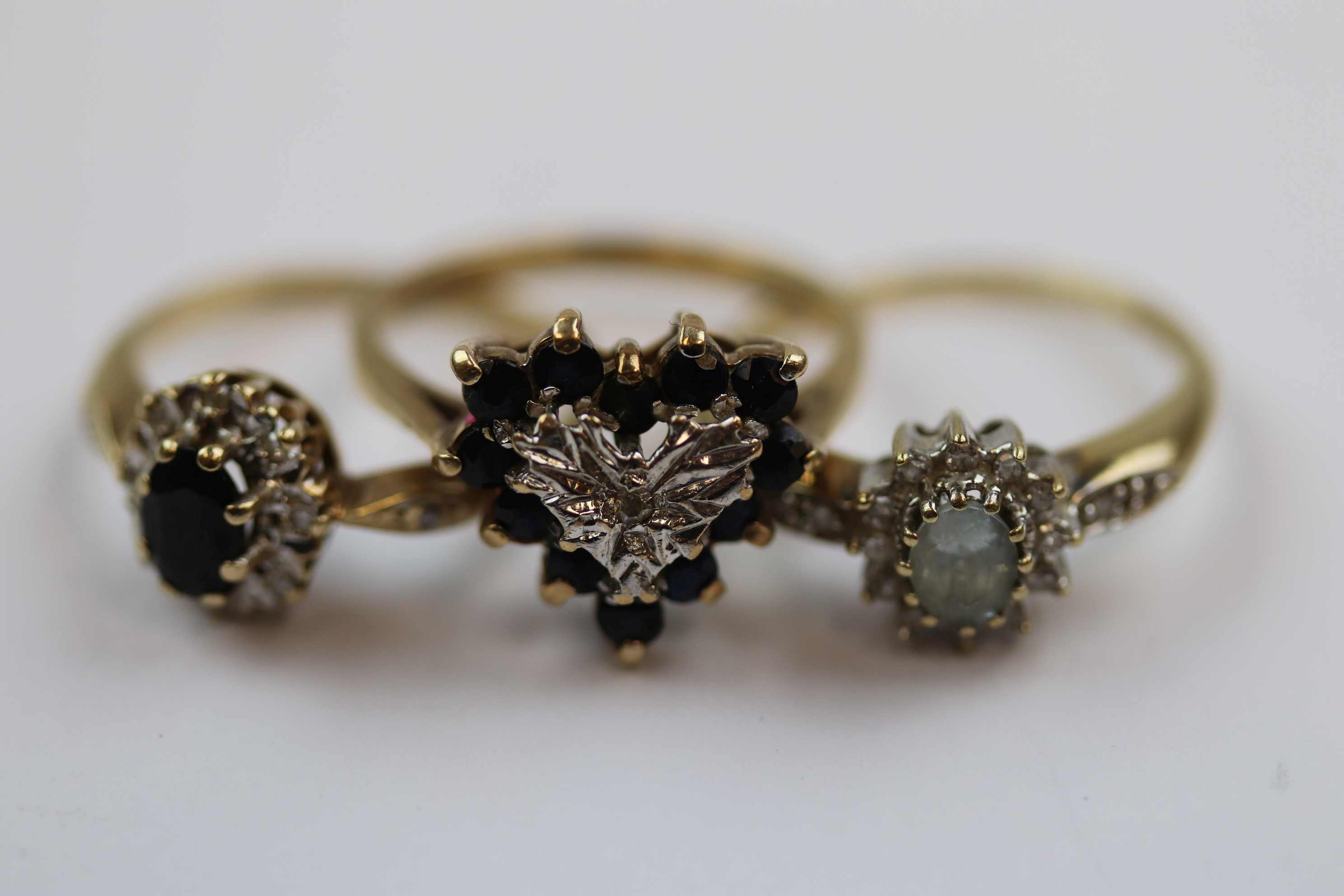 Three gem set 9ct yellow gold dress rings comprising diamond and sapphire heart shaped fancy cluster