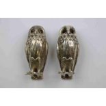 Pair of 20th century silver novelty pepper pots modelled as owls, yellow glass eyes, textured