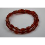 Carnelian graduated bead necklace, the largest beads measuring approximately 27mm length, thirty-one