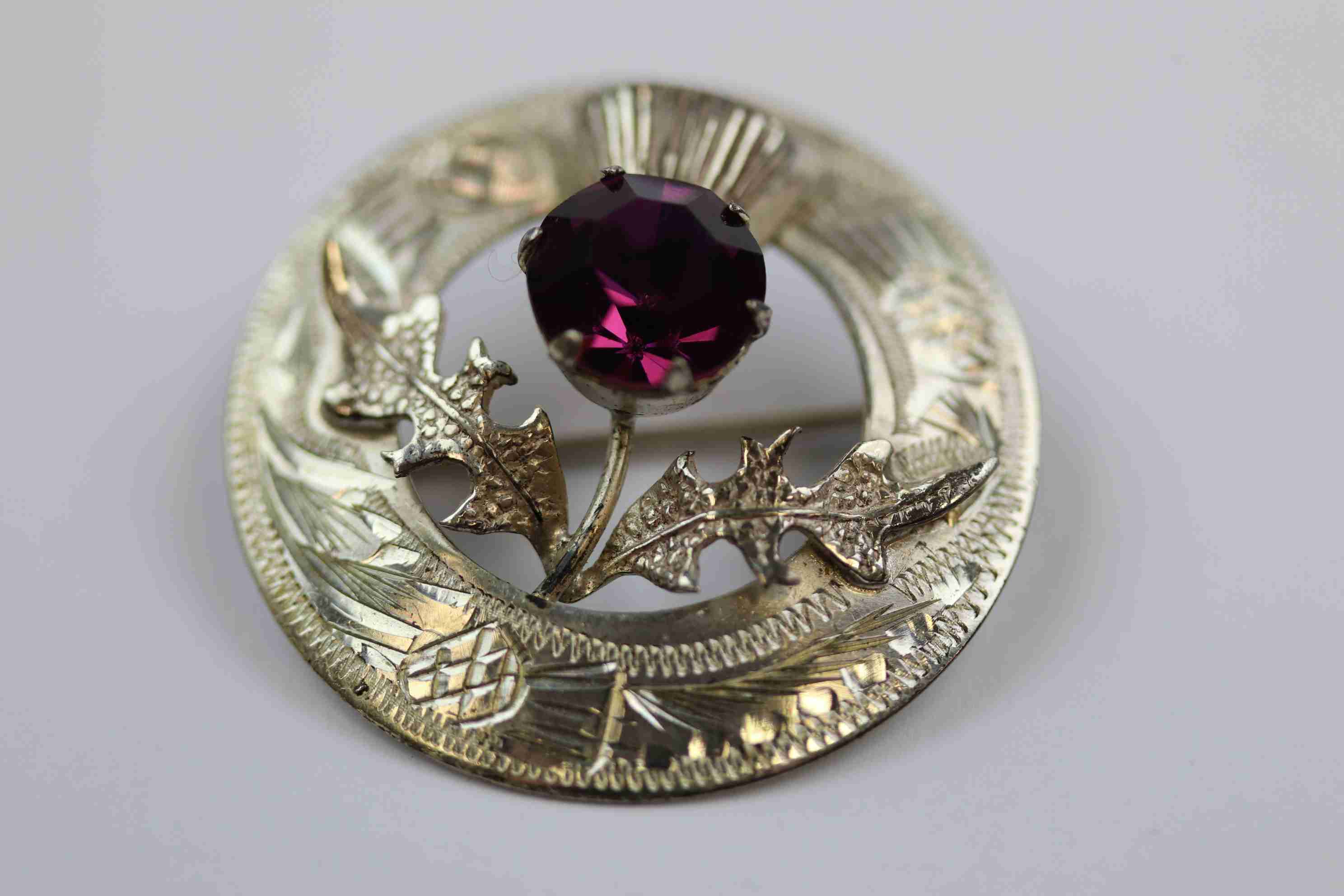 Mid twentieth century Scottish silver paste set thistle brooch, purple paste stone forming the - Image 3 of 7