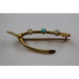 Early 20th century turquoise and seed pearl 10ct yellow gold wishbone brooch, the central cabochon