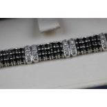 White diamond and black diamond 18ct white gold Art Deco style panel bracelet, each panel formed