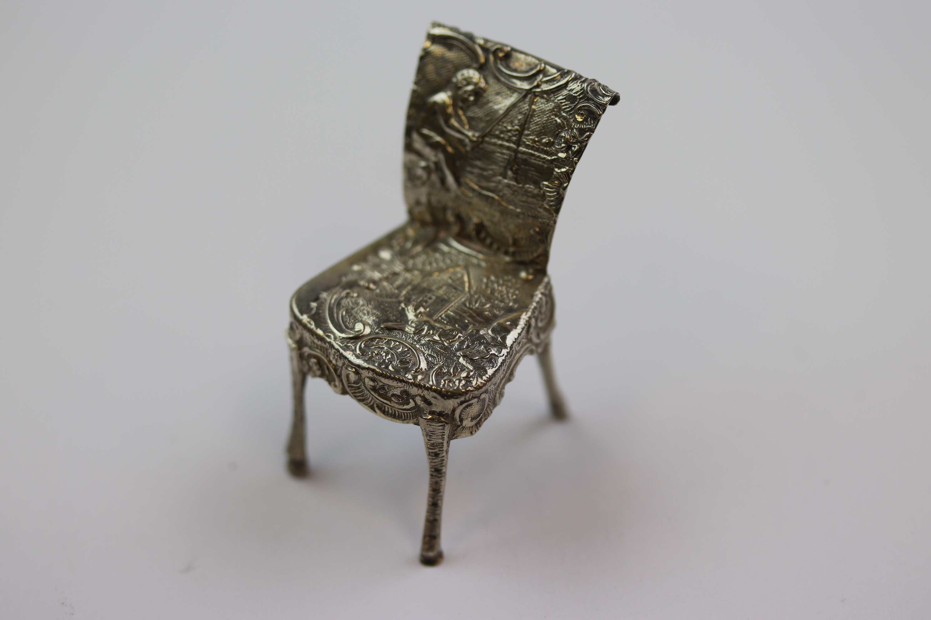 Dutch silver novelty miniature chair with repousse idyllic cottage and dog scene to seat and boy