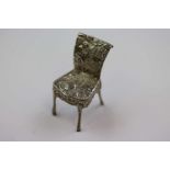 Dutch silver novelty miniature chair with repousse idyllic cottage and dog scene to seat and boy