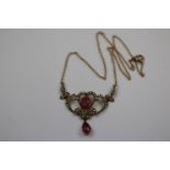 Edwardian pink tourmaline and seed pearl yellow gold (unmarked) pendant necklace, the scrolled