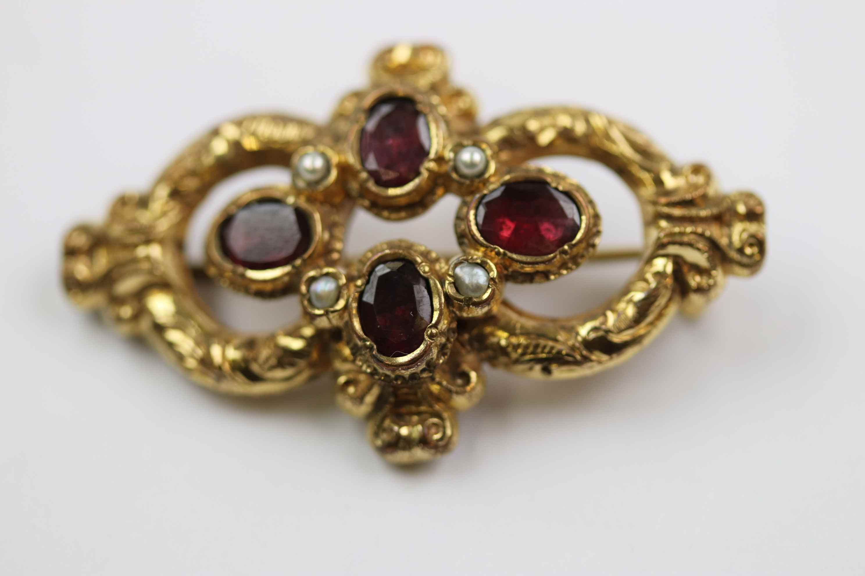 19th century garnet and seed pearl yellow metal brooch, four oval mixed cut garnets in quatre foil