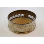 George III silver bottle coaster, the pierced collar with engraved repeating foliate decoration