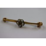 Diamond and seed pearl 15ct yellow gold flower head bar brooch, the flower head formed of five