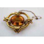 Victorian citrine yellow metal brooch, the central large oval mixed cut citrine measuring