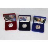 Three cased Royal Mint Silver proof Crown coins to include; Queen Mother Memorial 2002, Golden