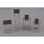 Four Asprey silver gilt topped cut glass dressing table jars, rectangular form with engine turned