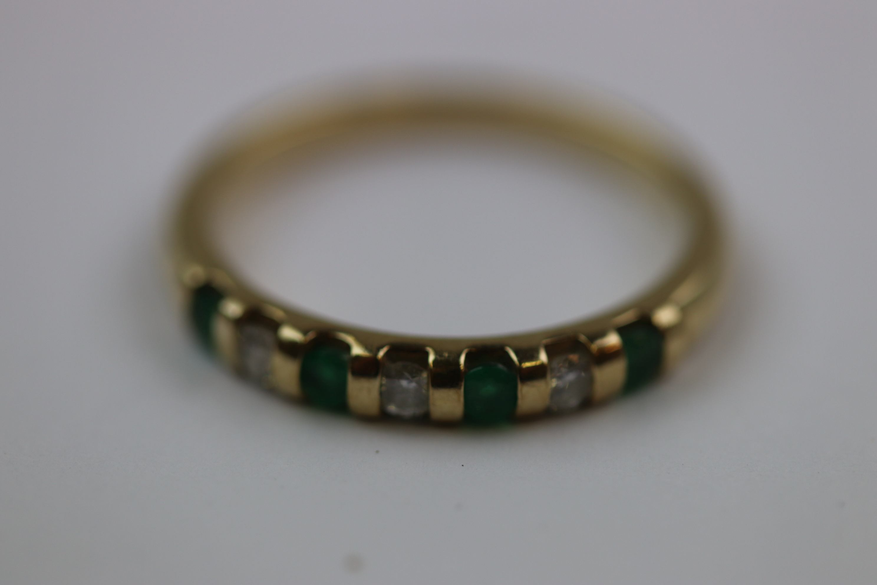 Emerald and diamond seven stone 9ct yellow gold dress ring, four small round mixed cut emerald and - Image 5 of 10