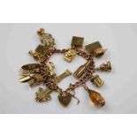 9ct rose gold curb link charm bracelet with 9ct yellow gold padlock clasp, seventeen charms in total