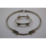 Modernist articulated silver matching necklace and bracelet suite, each curved panel linked to the