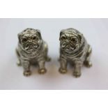 Pair of continental silver novelty salt and pepper pots modelled as sitting pug dogs, textured body,