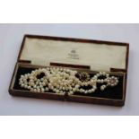 Freshwater pearl single strand necklace with red stone and pearl set yellow metal hook and box