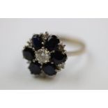 Diamond and sapphire flower head cluster 18ct white gold ring, the central round brilliant cut