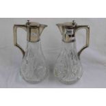 Pair of German silver mounted cut glass claret jugs, plain polished collar, hinged lid and handle,