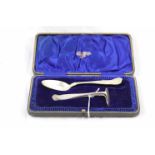 Cased silver spoon and crumb pusher, Kings pattern, Birmingham import mark and sponsors mark for