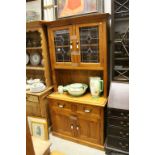 Pine Dresser, the upper section with glass doors above two drawers and two cupboards with iron and