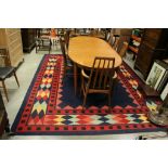 Large Blue Ground Woolen Rug with Plain Blue Central Panel surrounded by a Border of Coloured