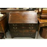 Early 19th century Oak Bureau, the drop front with fitted interior above Four Long Drawers and