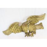 19th century Carved Giltwood Eagle with it's wings outstretched and holding a ring in it's mouth,