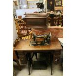 Vintage Singer Sewing Machine housed in an Oak Case on a Table with Drop Flap, Seven Drawers set