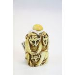 Carved bone snuff bottle depicting three monkeys, height approximately 7cm