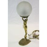 Art Deco Brass table Lamp modelled as a Nude Female, holding aloft a Crackle Glass ball shade,