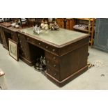 Victorian Oak Twin Pedestal Writing Desk with Green Leather Inset Top with an arrangement of nine