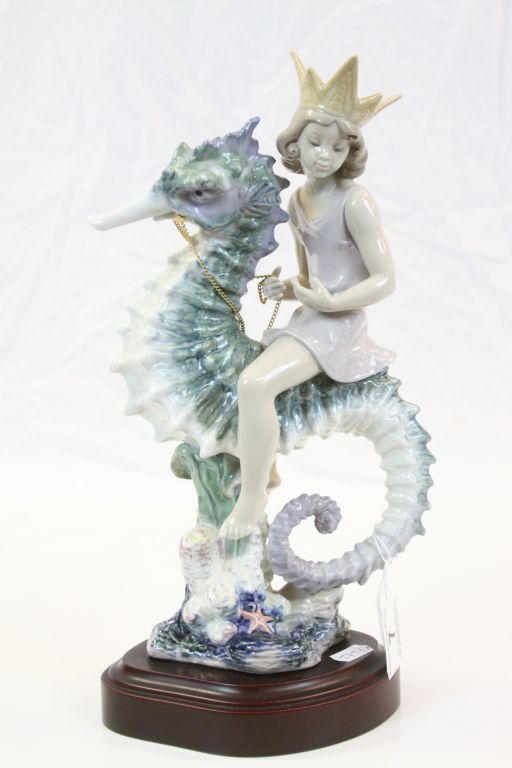 Large Lladro ceramic model "Mermaid on Seahorse", with attached wood effect base, stands approx 32cm