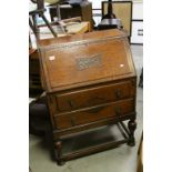 1930's / 40's Oak Bureau, the carved drop front opening to reveal a fitted interior over Two Long