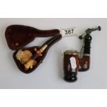 Novelty pipe with carved owl, cased together with a Swiss souvenir tobacco pipe (2)