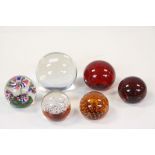 Five Glass Paperweights including Bubble Control and an Atlantis Crystal Ball