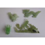 Jade type carved dragon, jade type carved rooster, soapstone carved mythical figure and a glass