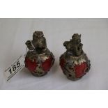 Pair of Small White Metal Dogs of Foe stood on Red Balls