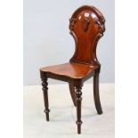 Victorian Mahogany Hall Chair, the shaped back with raised shield decoration