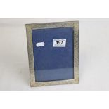 White metal easel back rectangular photograph frame, engraved foliate scroll decoration, height