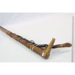 Two Wooden Walking sticks, one with South American style decoration, the other naturalistic with