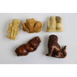 Five carved hardwood and resin netsukes to include Dog of Fo, Skeleton, Dragon, Elder and boy with